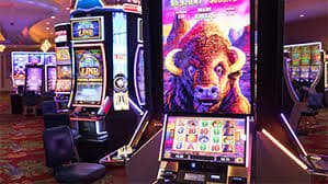 totojitu 777 slot game display showing reels, stake controls, and win notification
